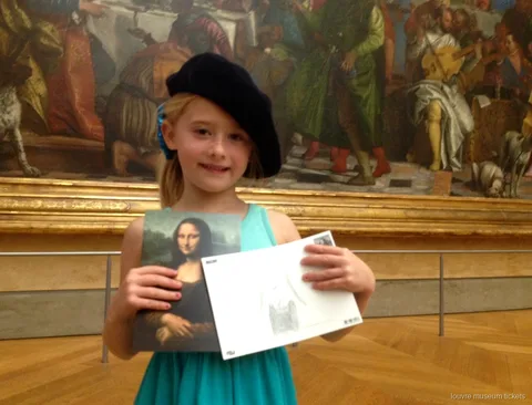 Girl in a beret holding a Mona Lisa postcard and her sketch on a family tour with Louvre Museum tickets